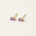 14K solid gold purple baguette stud earrings on a warm ivory background