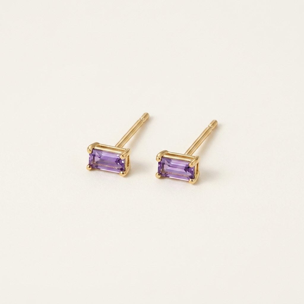 14K solid gold purple baguette stud earrings on a warm ivory background