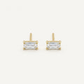 14K solid gold clear baguette stud earrings on a warm ivory background