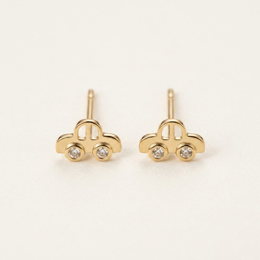 14K solid gold playful car stud earrings on a warm ivory background