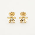 14K solid gold open petal flower stud earrings on a warm ivory background