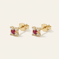 14K solid gold ruby flower cluster stud earrings on a warm ivory background