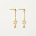 14K solid gold double star stud earrings on a warm ivory background