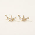14K solid gold crystal leaf climber stud earrings on a warm ivory background