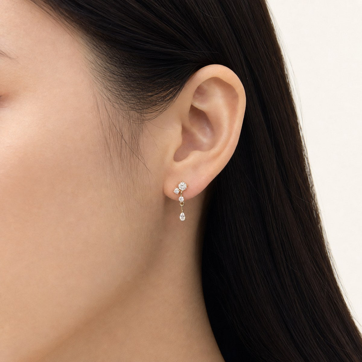 14K solid gold teardrop bar drop stud earrings worn on an ear