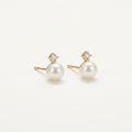 14K solid gold stone-set stud earrings on a warm ivory background