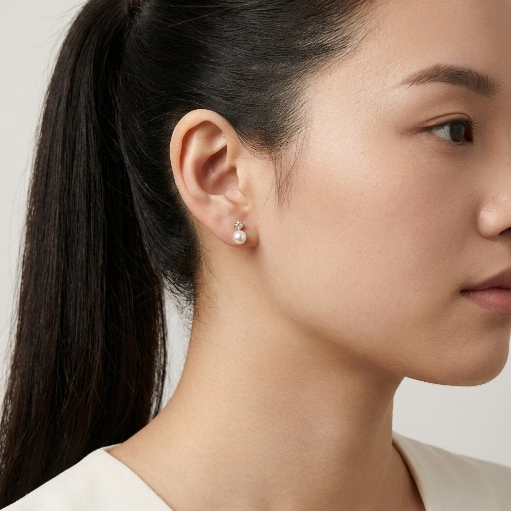 14K solid gold pearl crystal pair stud earrings worn on an ear