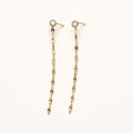 14K solid gold bezel stone chain drop earrings on a warm ivory background