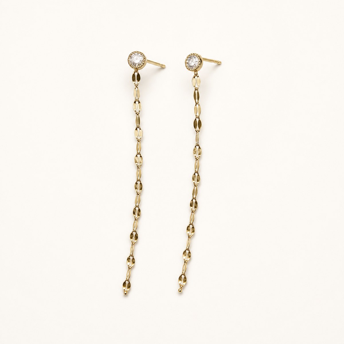 14K solid gold bezel stone chain drop earrings on a warm ivory background