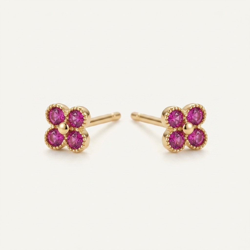 14K solid gold ruby clover stud earrings on a warm ivory background