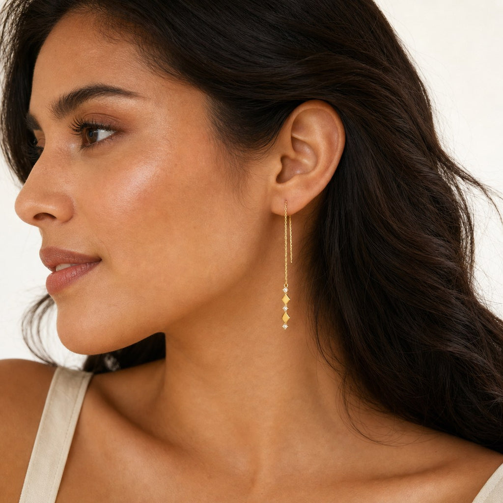 14K solid gold geometric bar chain drop earrings worn on an ear
