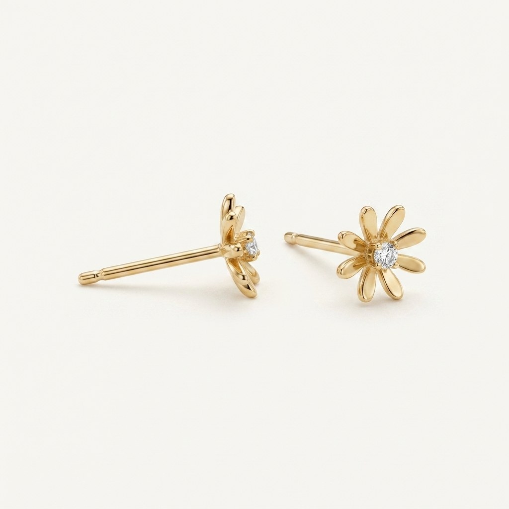14K solid gold open daisy stud earrings on a warm ivory background