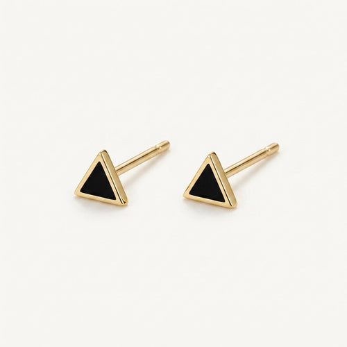 14K solid gold black triangle stud earrings on a warm ivory background