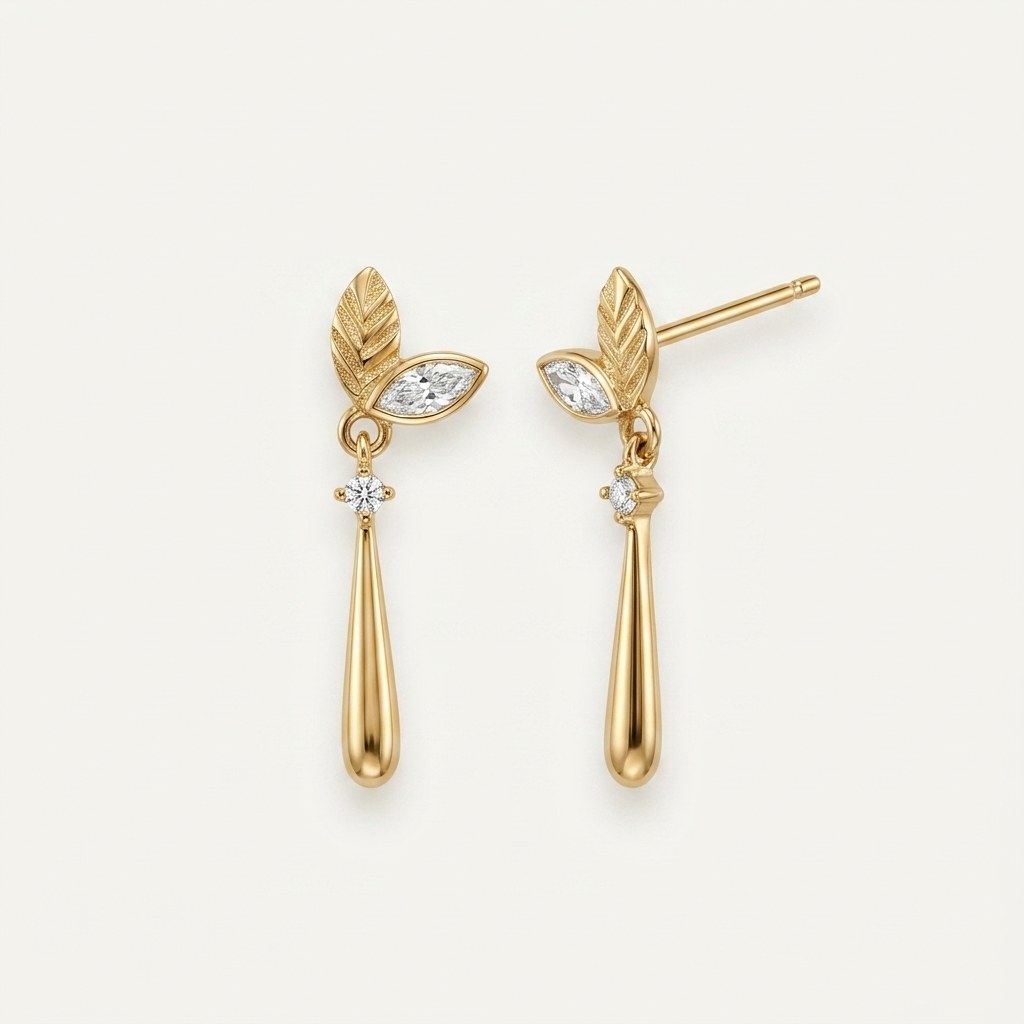 14K solid gold leaf teardrop drop stud earrings on a warm ivory background