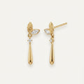 14K solid gold leaf teardrop drop stud earrings on a warm ivory background