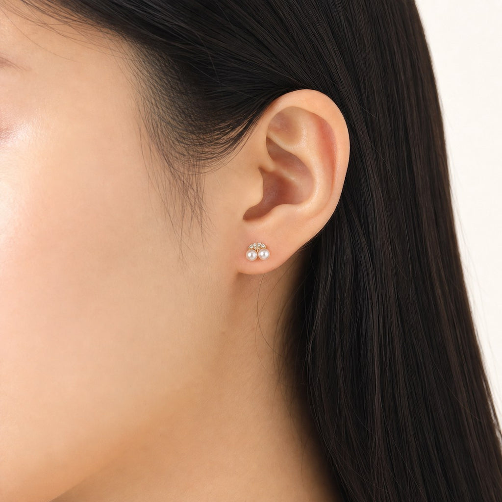 14K solid gold pearl crystal cluster stud earrings worn on an ear