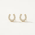 14K solid gold crystal horseshoe stud earrings on a warm ivory background
