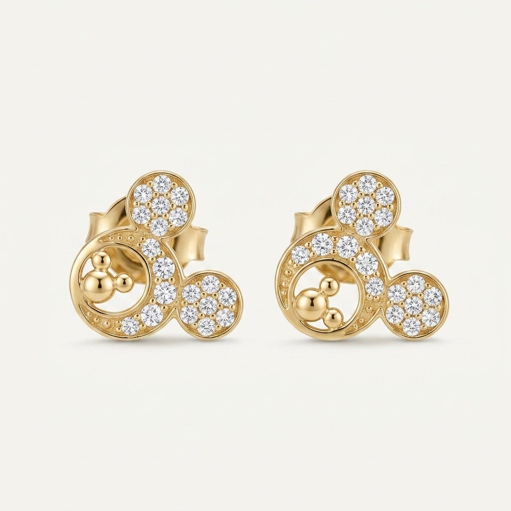 14K solid gold crystal bear paw stud earrings on a warm ivory background