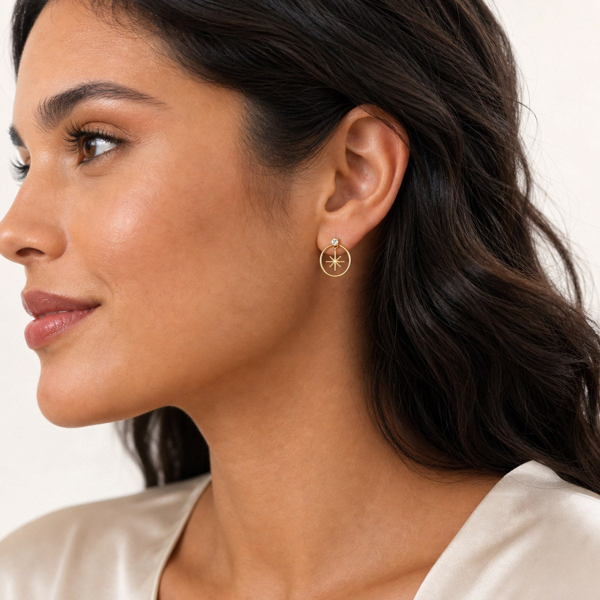 14K solid gold star circle drop stud earrings worn on an ear