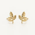 14K solid gold textured leaf branch stud earrings on a warm ivory background
