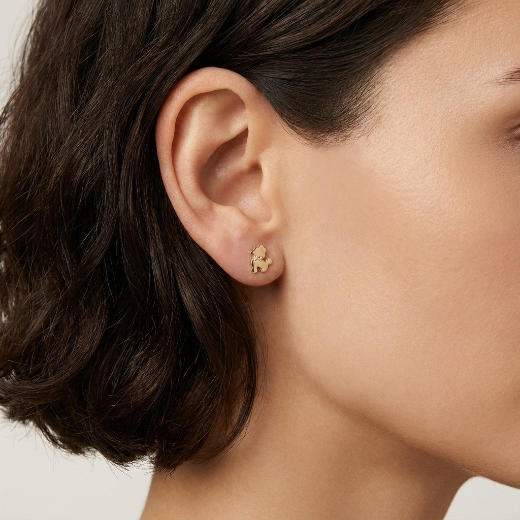 14K solid gold crystal teddy bear stud earrings worn on an ear