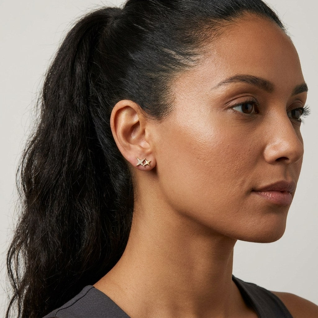 14K solid gold sparkle shooting star stud earrings worn on an ear