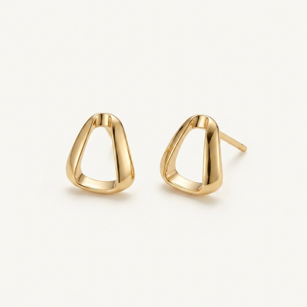 14K solid gold sculpted teardrop stud earrings on a warm ivory background