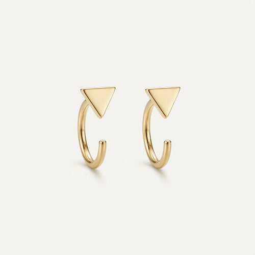 14K solid gold stud earrings on a warm ivory background