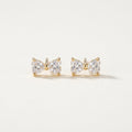 14K solid gold stone-set stud earrings on a warm ivory background
