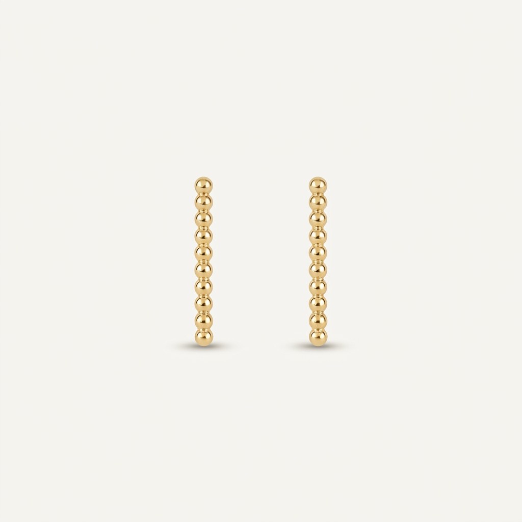 14K solid gold stud earrings on a warm ivory background