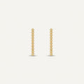 14K solid gold stud earrings on a warm ivory background