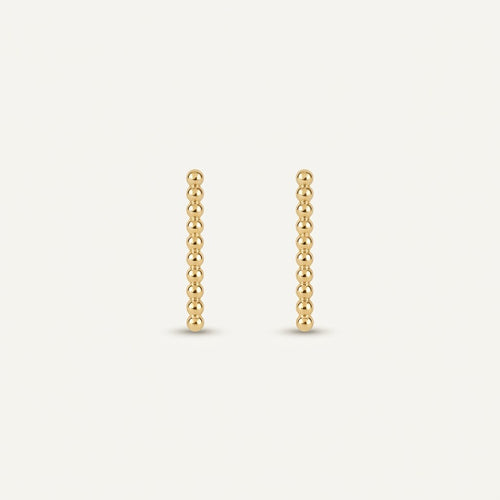 14K solid gold stud earrings on a warm ivory background