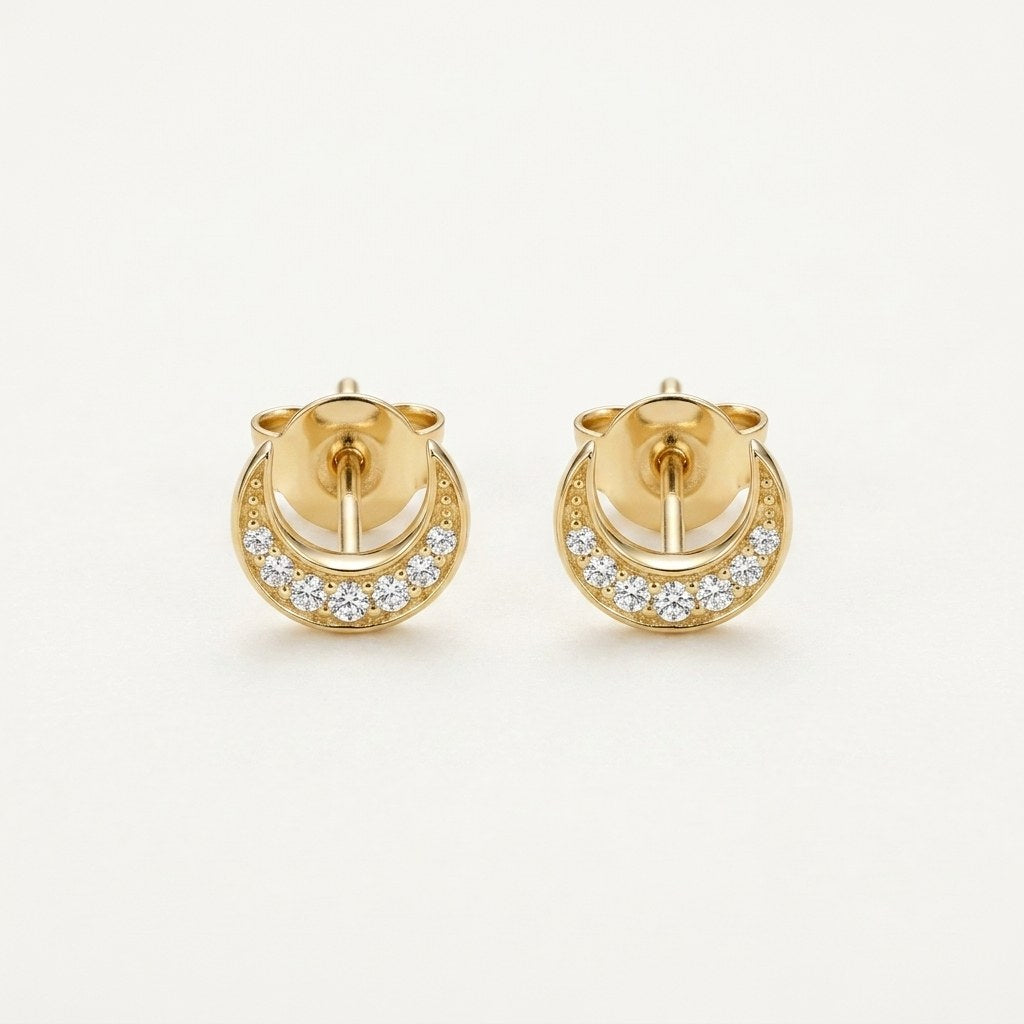 14K solid gold crescent crystal halo stud earrings on a warm ivory background