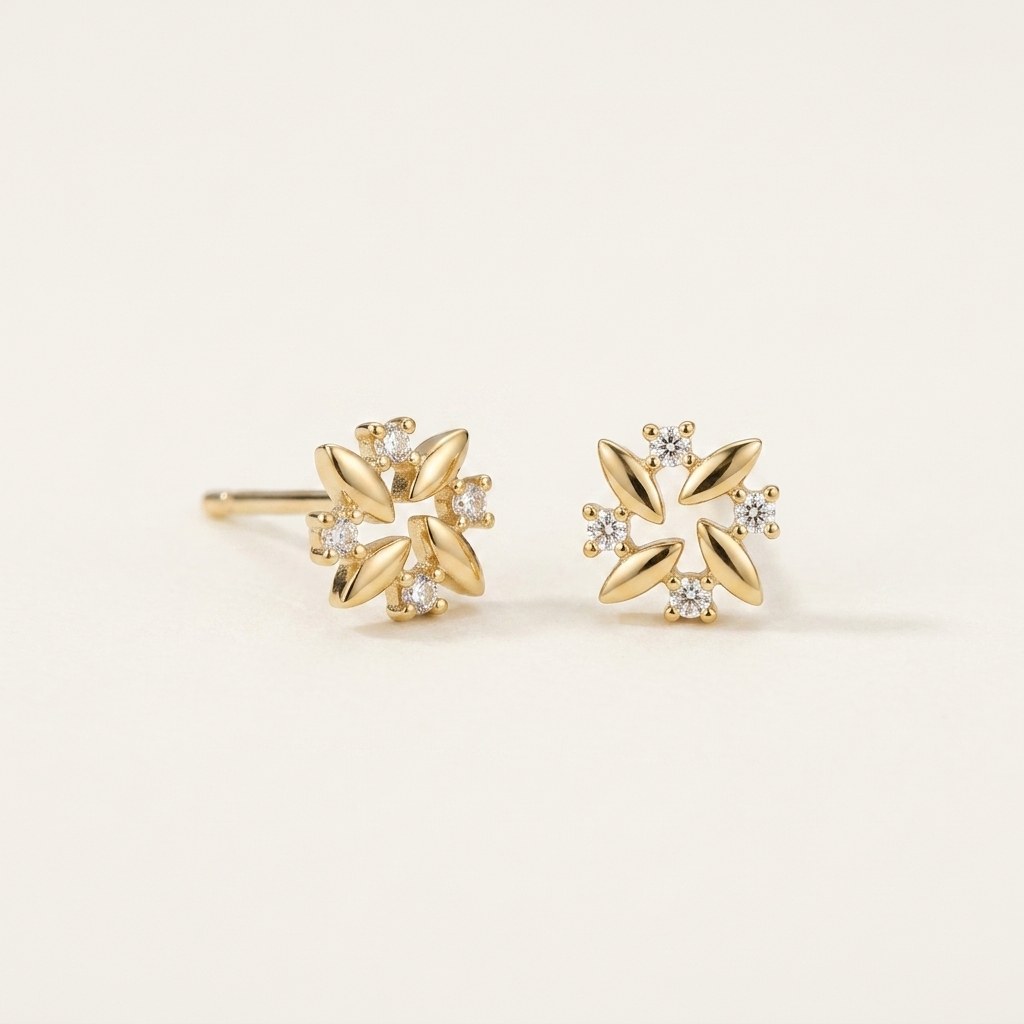 14K solid gold crystal pinwheel flower stud earrings on a warm ivory background