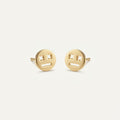 14K solid gold stud earrings on a warm ivory background