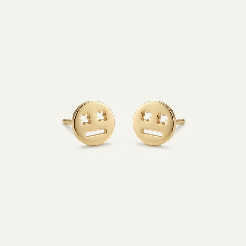 14K solid gold stud earrings on a warm ivory background