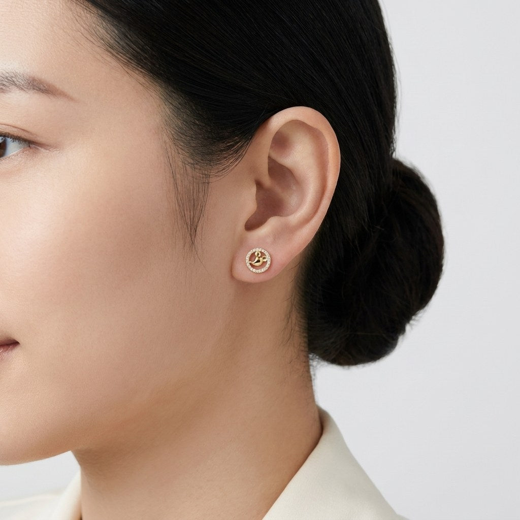 14K solid gold rose crystal halo stud earrings worn on an ear