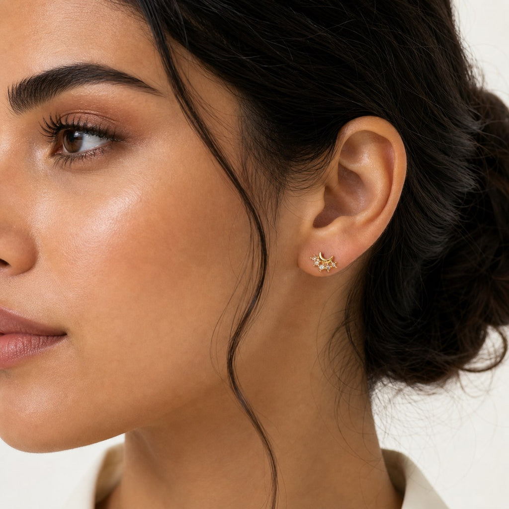 14K solid gold crescent crystal cluster stud earrings worn on an ear