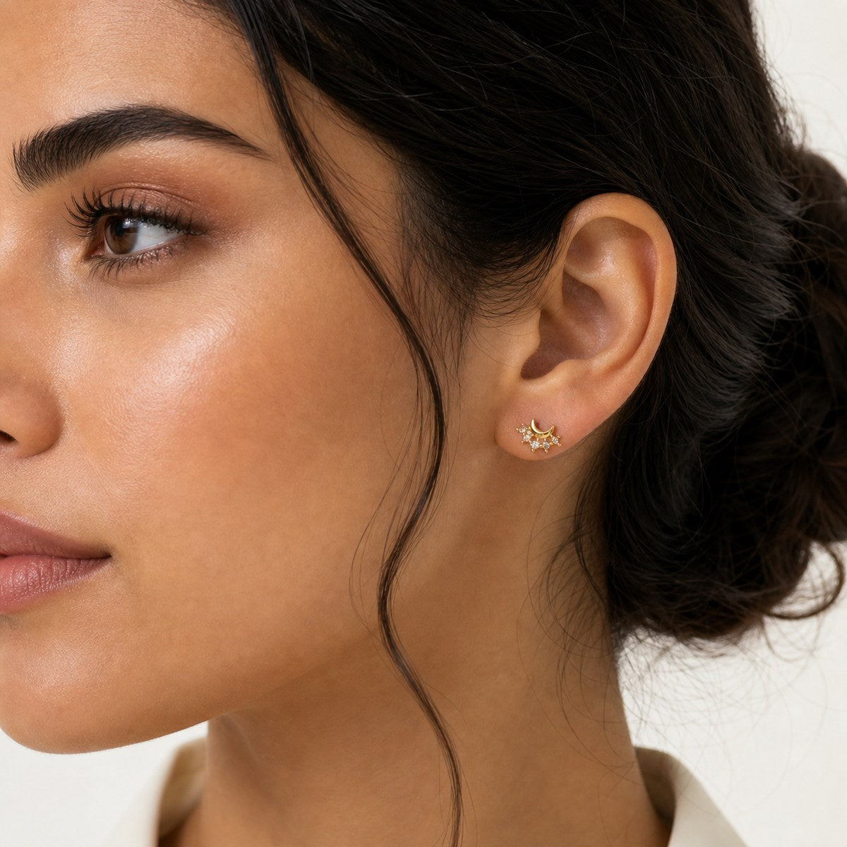 14K solid gold crescent crystal cluster stud earrings worn on an ear