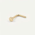 Solid Gold Disc Nose Stud in yellow gold on a warm ivory background
