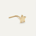 Solid Gold Star Nose Stud in yellow gold on a warm ivory background