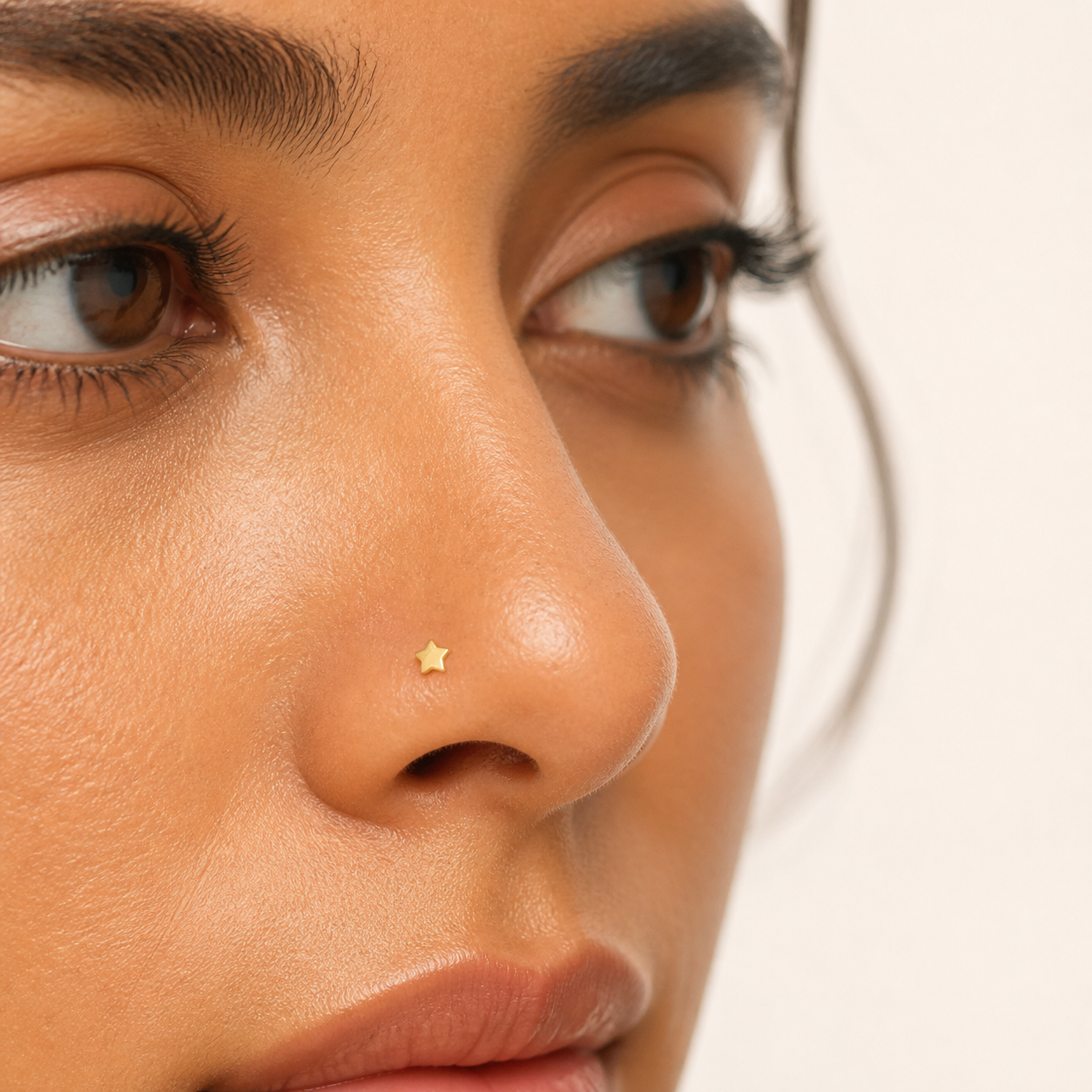 Solid Gold Star Nose Stud worn on the nose