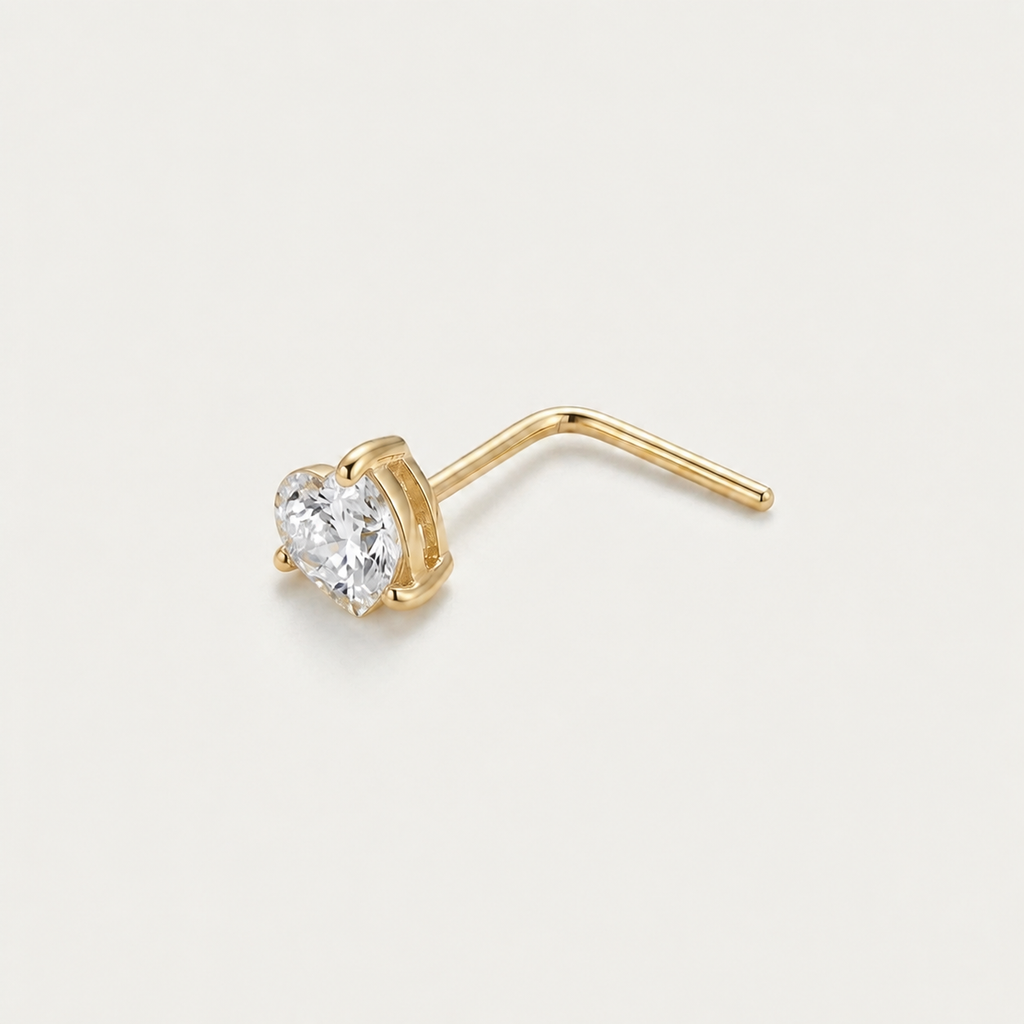 Solid Gold Heart Gemstone Nose Stud in yellow gold on a warm ivory background