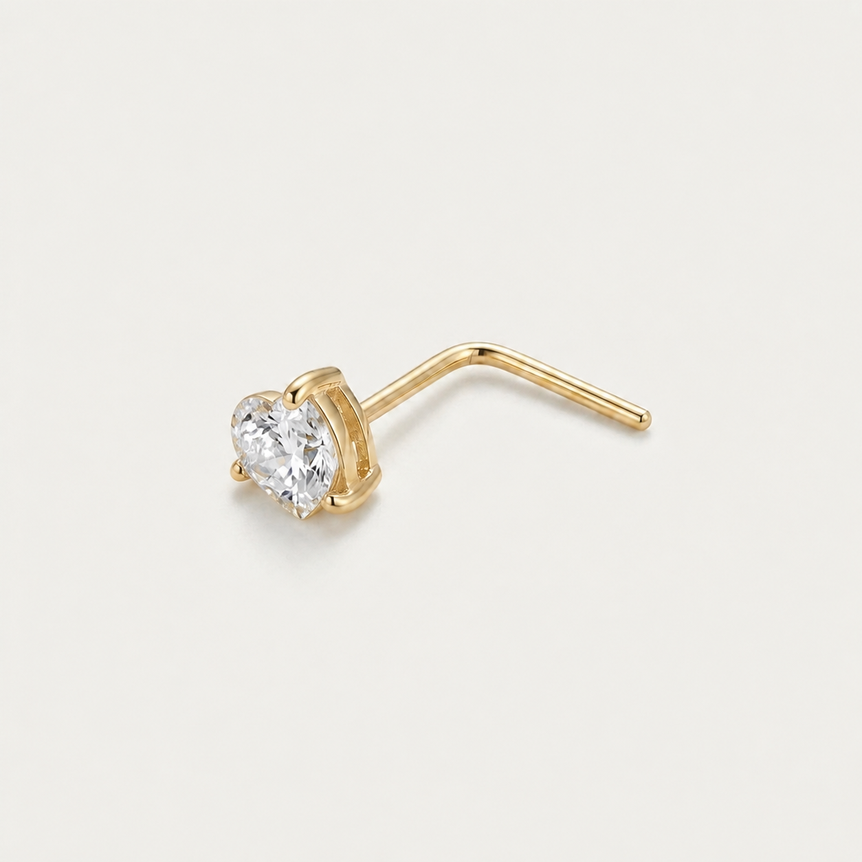 Solid Gold Heart Gemstone Nose Stud in yellow gold on a warm ivory background