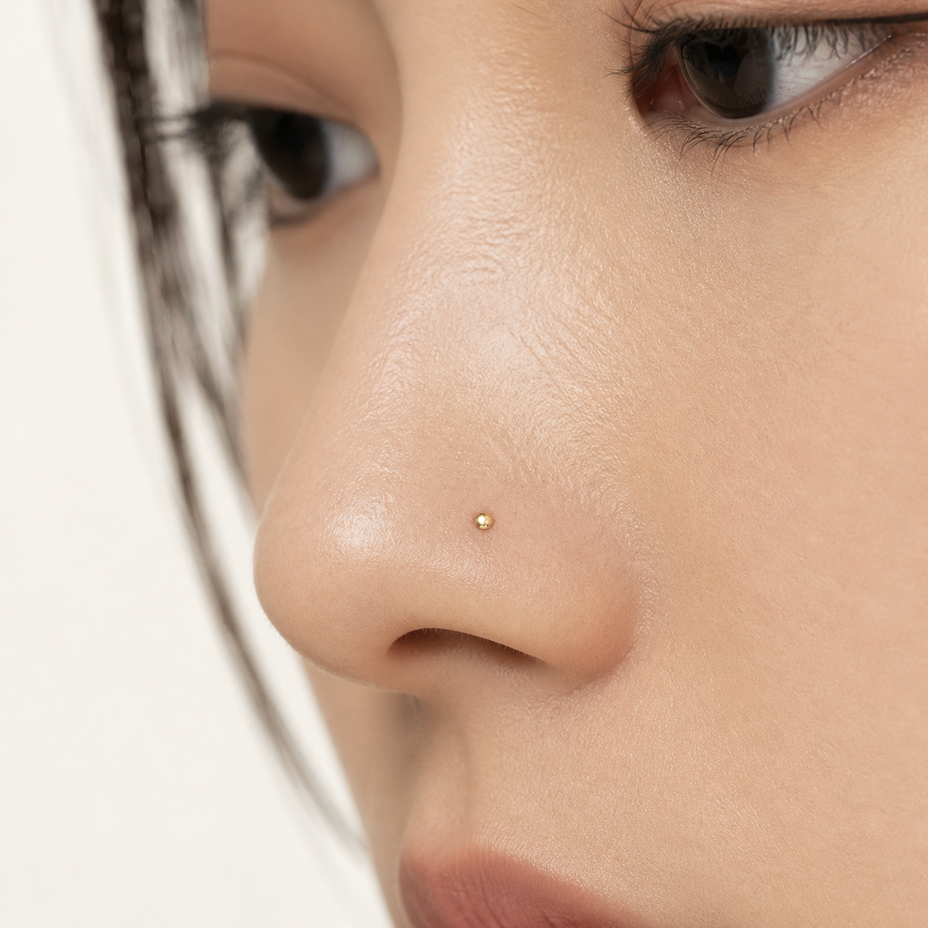 Solid Gold Flat Disc Nose Stud worn on the nose