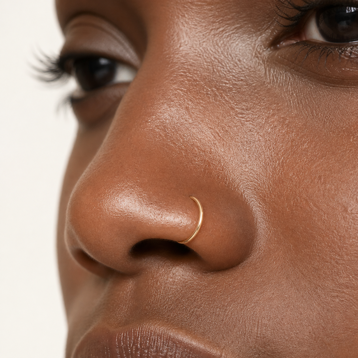 Solid Gold Seamless Nose Hoop worn on the nose